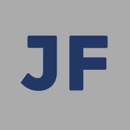 Dark blue capital letters "J" and "F" are centered on a light gray background. The bold, sans-serif font creates a simple and modern appearance, reflecting a minimalistic style often appreciated by Kurt Uhlir. No other elements or decorations are present.