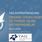 A blue presentation slide with a bullseye and arrow graphic on the left. Text reads: "TAG Entrepreneurs: Finding Your Cadence to Thrive as an Entrepreneur." Below is "Kurt Uhlir, CEO & Co-founder, Sideqik" and the TAG (Technology Association of Georgia) logo.