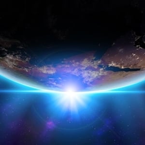 A view of Earth from space with the sun rising behind the planet, casting a bright blue glow on the horizon. Perfect inspiration to create a real estate website as vast and stunning as our world—limitless possibilities beneath a starry sky.