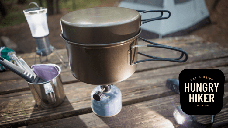 This photo shows a canister-fuel backpacking stove at work on a picnic table.