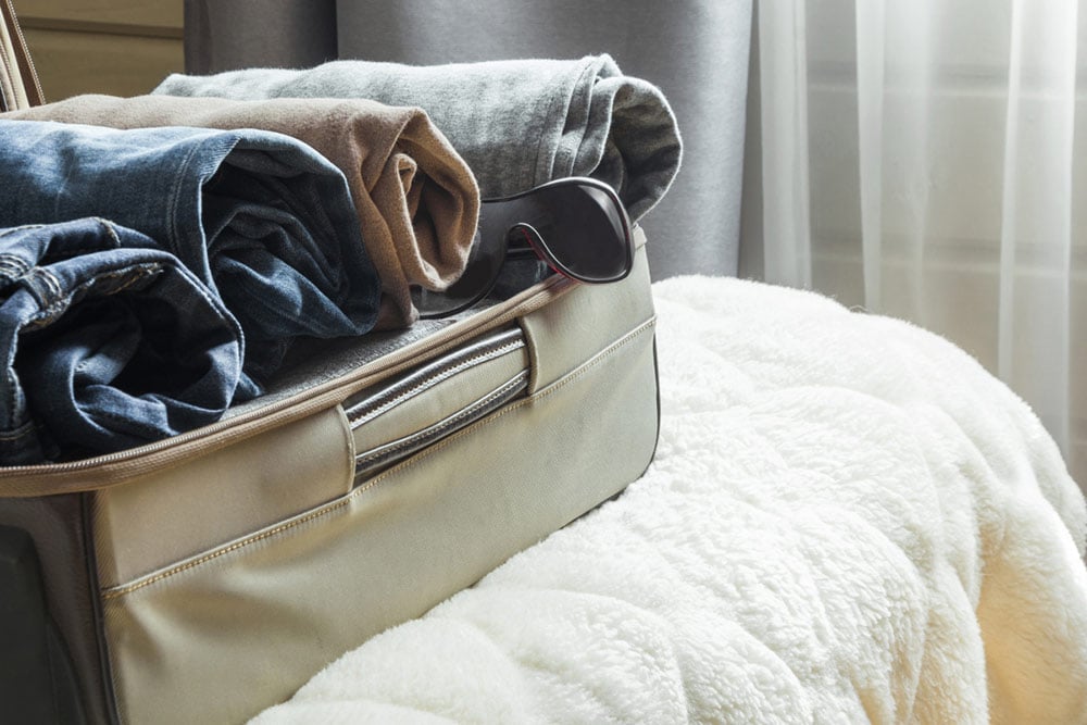 roll clothes in suitcase