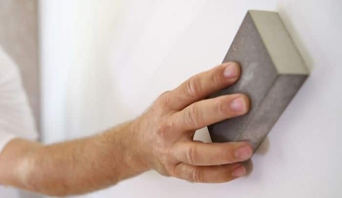 Hand Sanding A Wall to Prepare For Painting