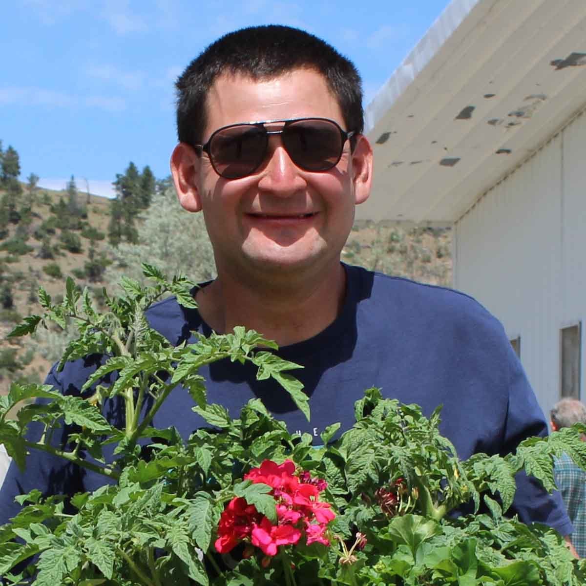 special k worker holding a flower starter