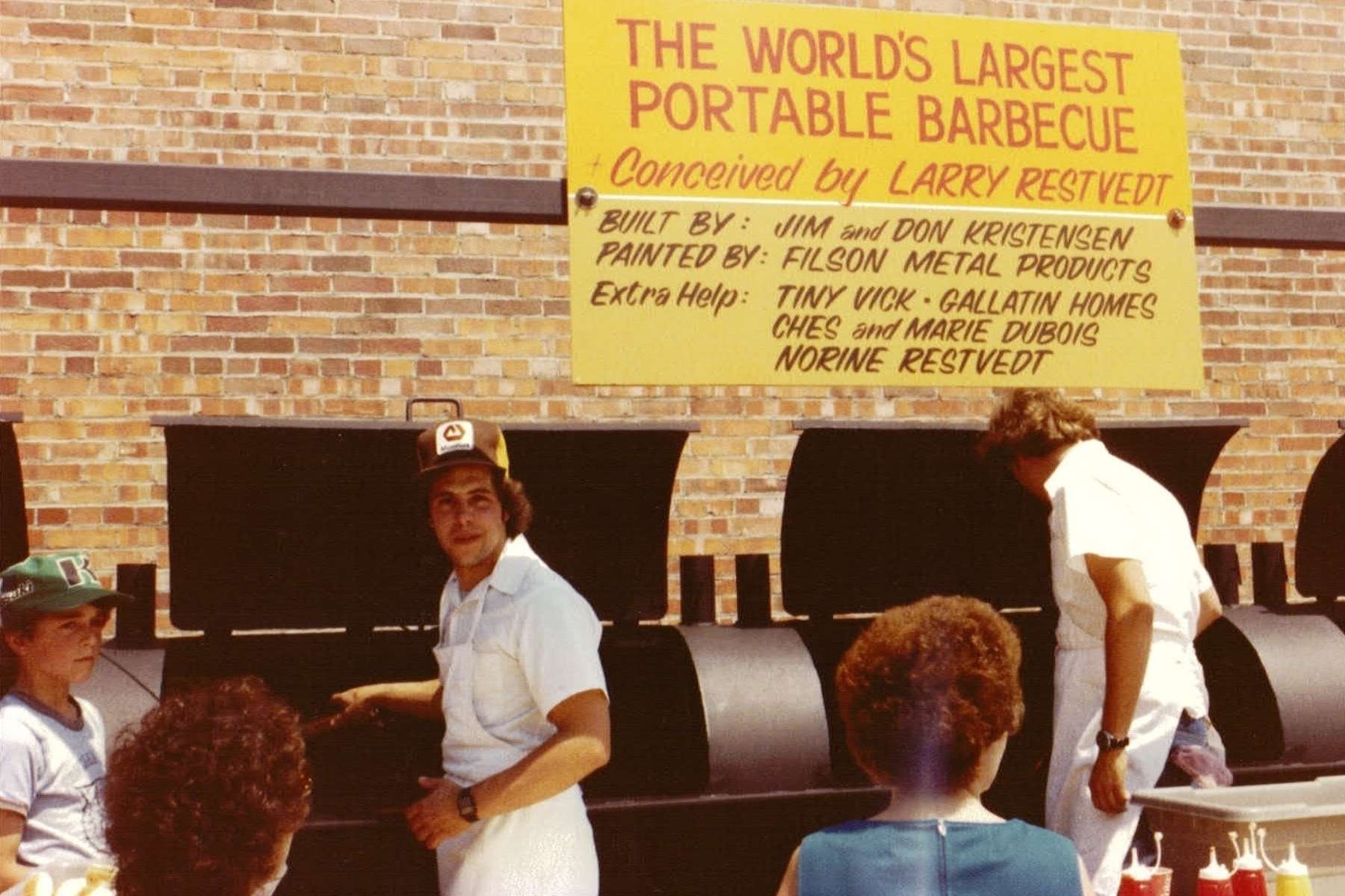image with STIHL demo - two males grilling with onlookers
