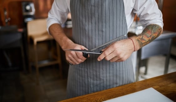 person sharpening knife 