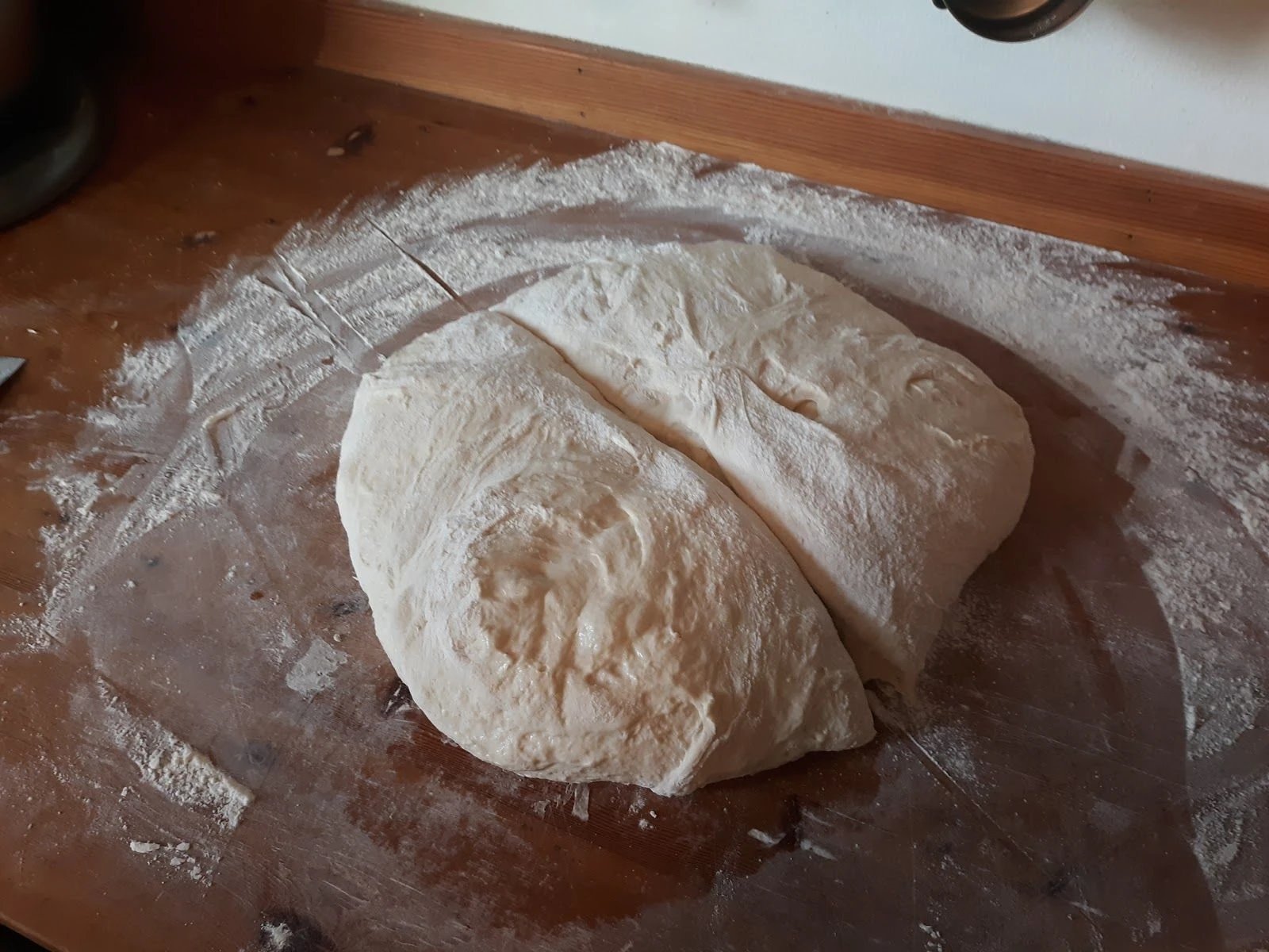 cutting bread dough in half