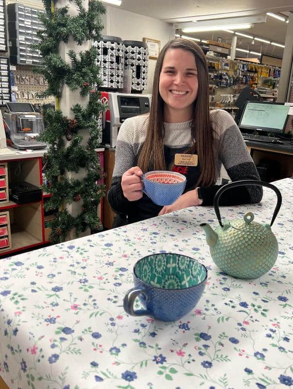 Ace Team Member Showing Tea Pot & Cups