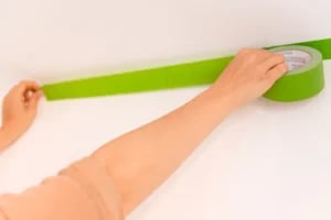 applying masking tape to the walls