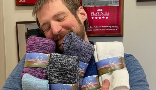 man snuggling alpaca wool socks