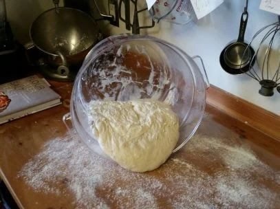 pouring bread dough on a floured surface