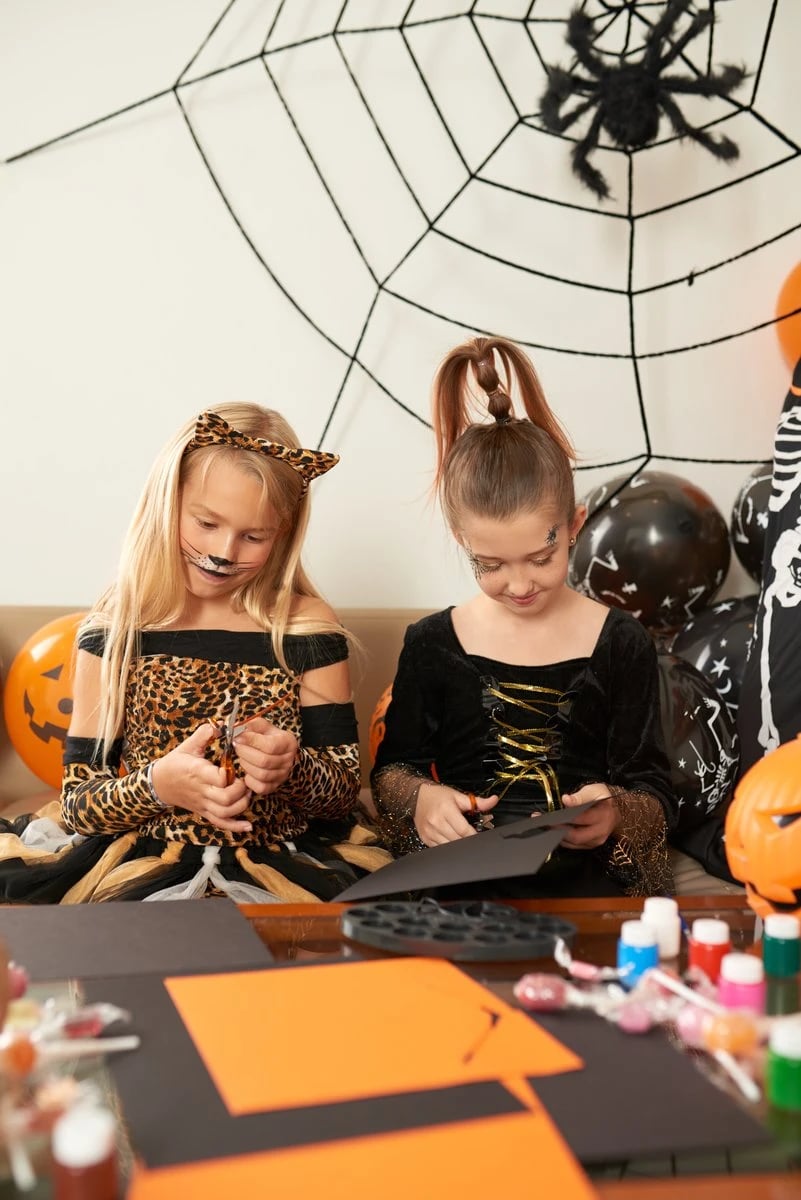 DIY Halloween Crafts for kids with orange paper and homemade spiders