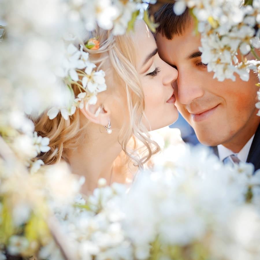 bigstock-Kissing-wedding-couple-in-spri-12138419