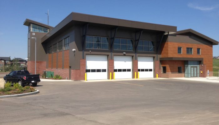 Cover Photo_Simons Valley Fire Hall a house that has a sign on the side of a road