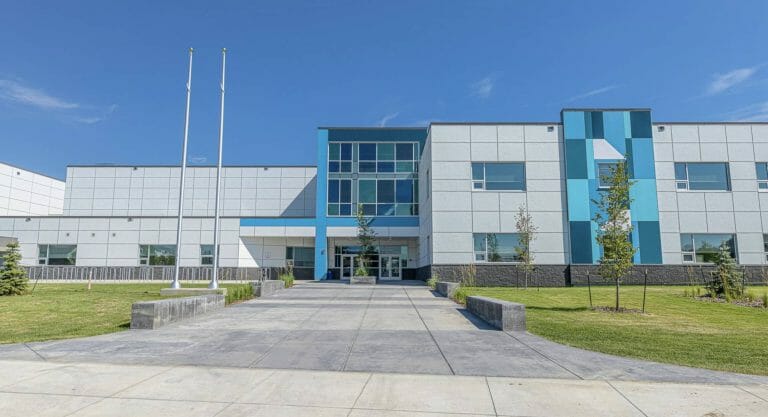 a building with a clock on the side of a road