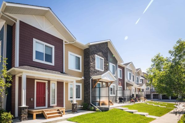 Canals 44 Apartment a large brick building with grass in front of a house