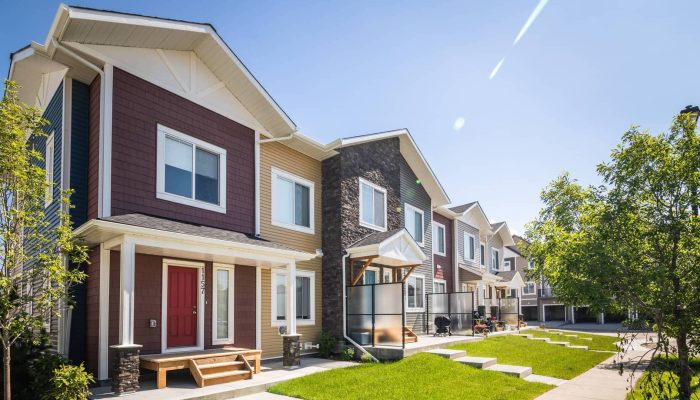 Canals 44 Apartment a large brick building with grass in front of a house