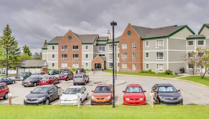 Cover Photo_CrossroadsCourt037 a car parked in front of a house