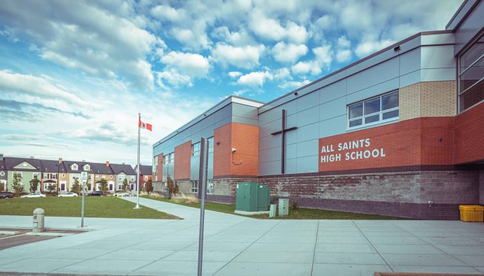 all saints high school a sign on the side of a building