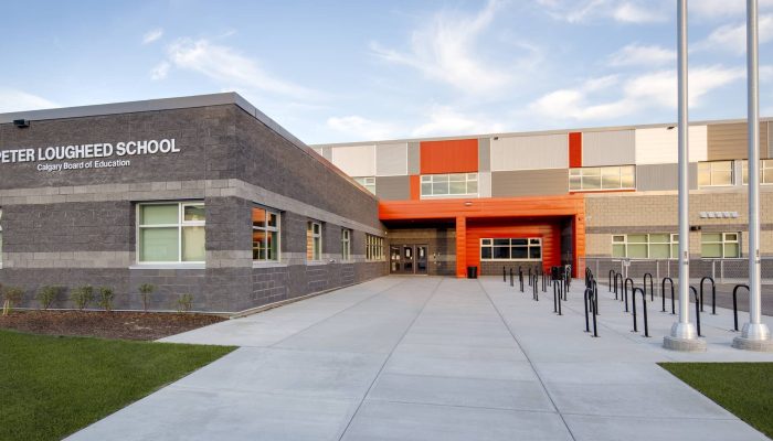 Peter Lougheed a person standing in front of a building