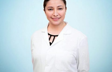 A confident healthcare professional wearing a white lab coat against a blue background. A confident healthcare professional wearing a white lab coat against a blue background.
