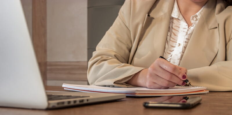 Woman Writing on Her Notebook