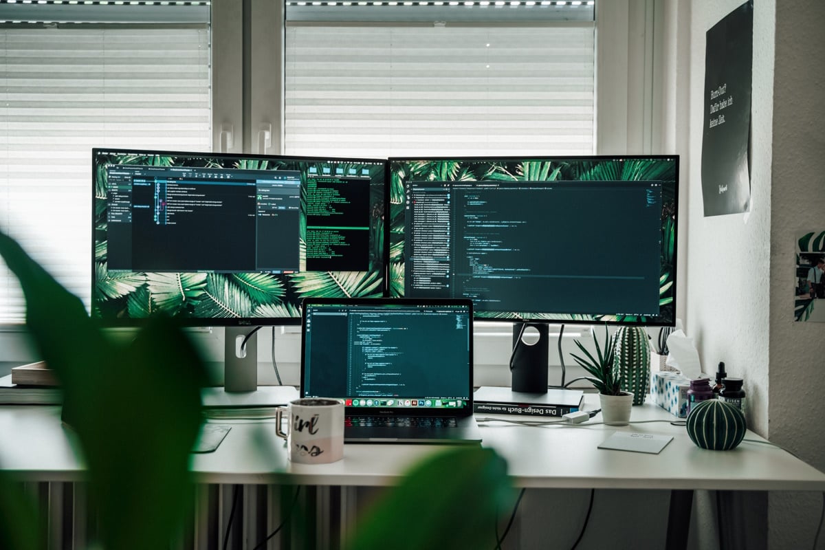 black flat screen computer monitor on white wooden desk