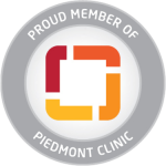 Circular badge with the text "Proud Member of Piedmont Clinic" surrounding a square, red and orange abstract logo in the center.