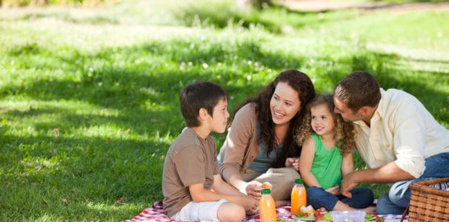 How to Throw the Perfect Birthday Picnic Family picnicking together