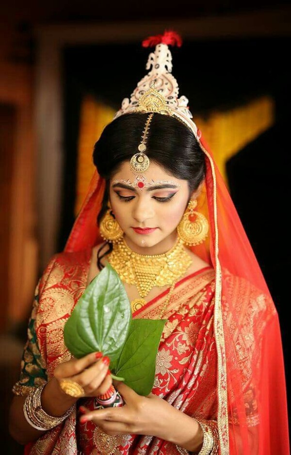 Shy Smile with Betel Leaf Bengali Bridal Poses