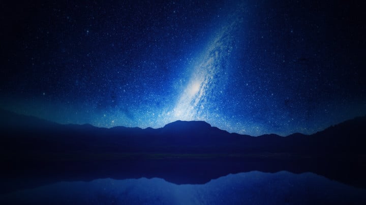 Lovely picture of a blue bright night featuring stars and a galaxy at a distant view from a lake. This is our featured image for No Relent TV astrology category.