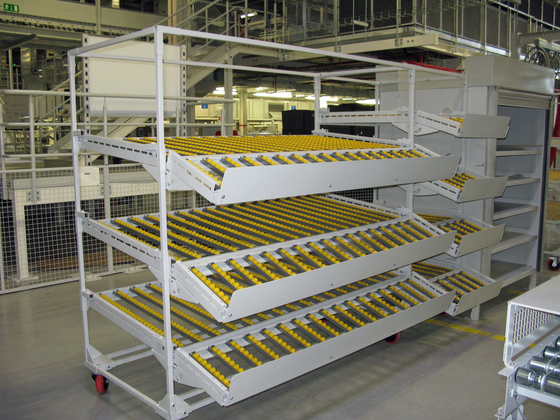 Large trolley with nylon plastic roller conveyor bearing wheels Image showing a trolley with yellow plastic conveyor bearing wheels