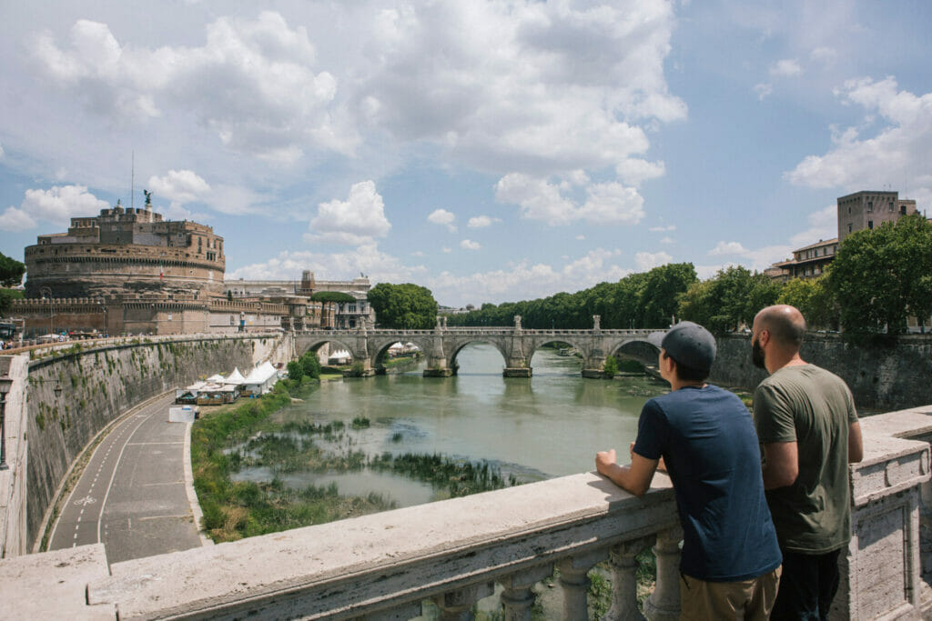 a man standing on a bridge over a body of water