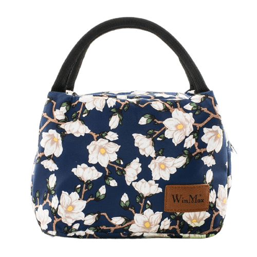 sac isotherme à fleurs blanches sur fond bleu, idéal pour garder vos aliments et boissons au frais, avec une poignée noire pour un transport facile et une finition élégante.