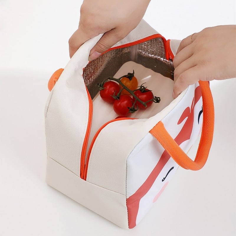 Sac isotherme avec fermeture éclair, conçu pour garder les aliments au frais, avec des poignées orange et un intérieur isolant, contenant des tomates.
