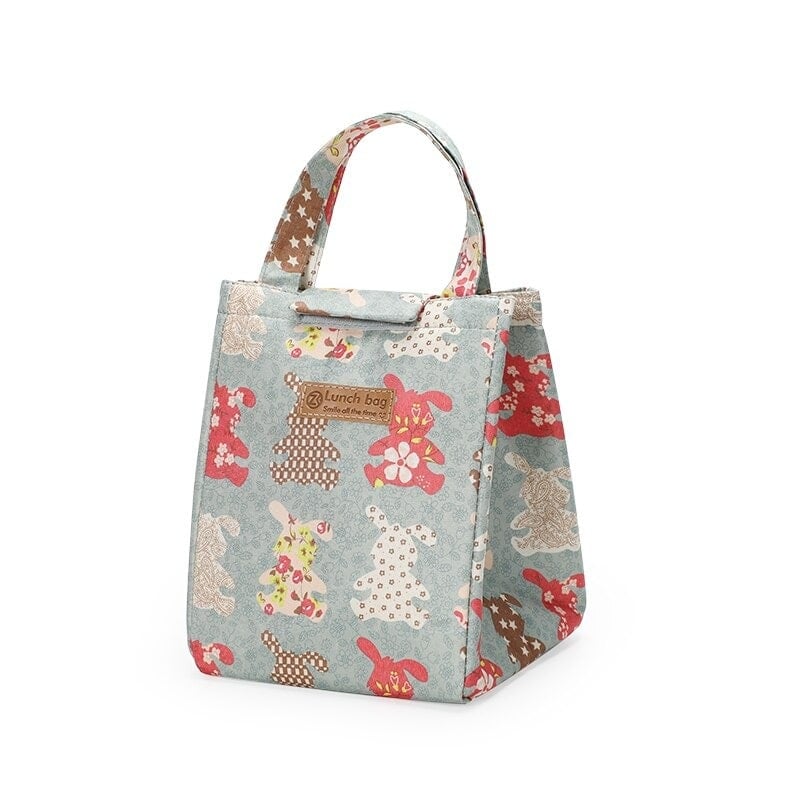 Sac isotherme pour le déjeuner avec un design coloré de lapins, idéal pour conserver les aliments à la bonne température.
