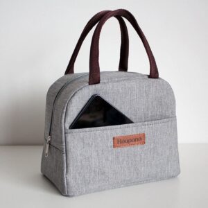 sac isotherme gris avec poignes marron et poche avant, idéal pour transporter des repas et des boissons au frais