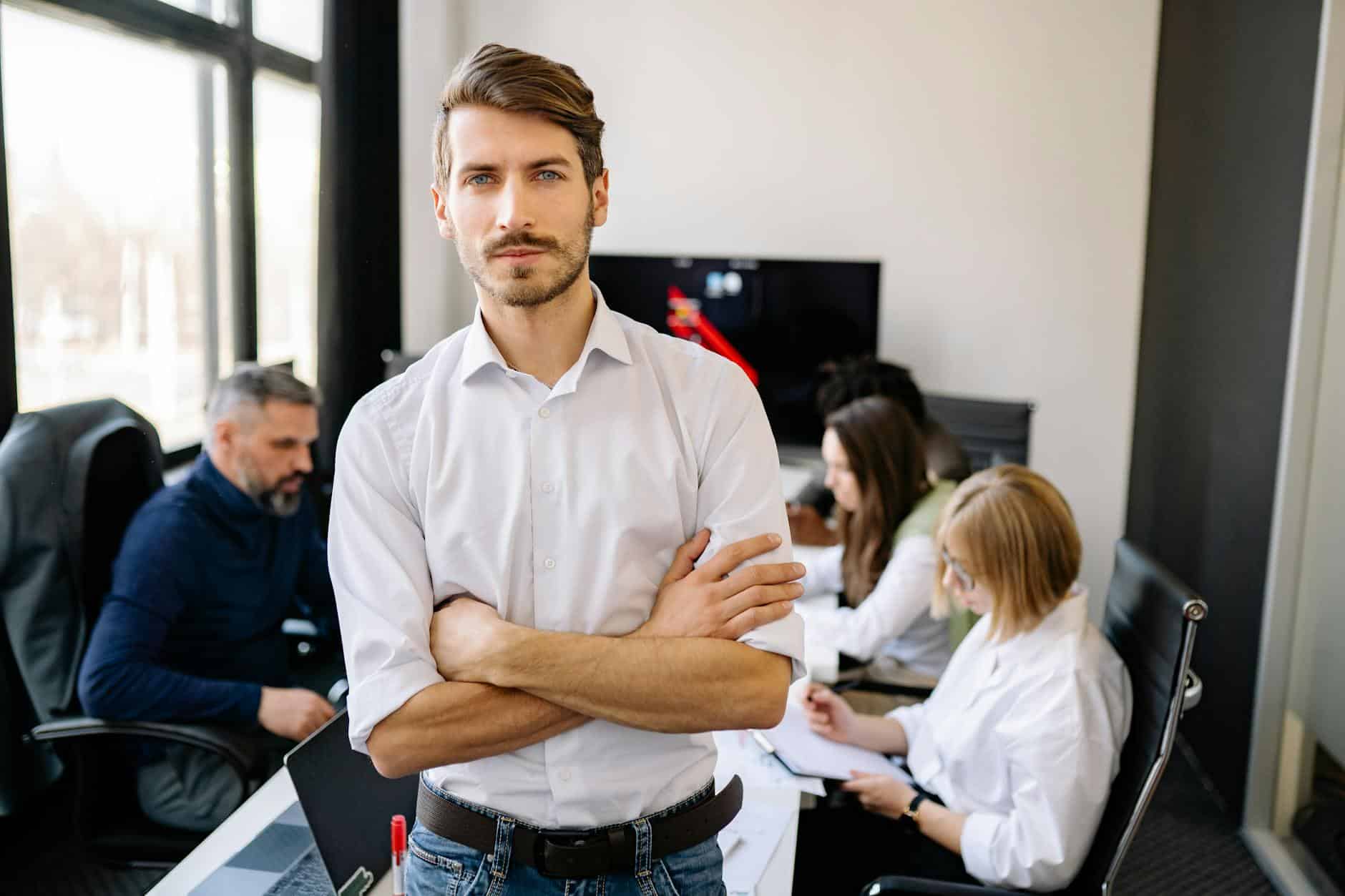 A man stands in front of a group of people in an office, discussing data encryption.