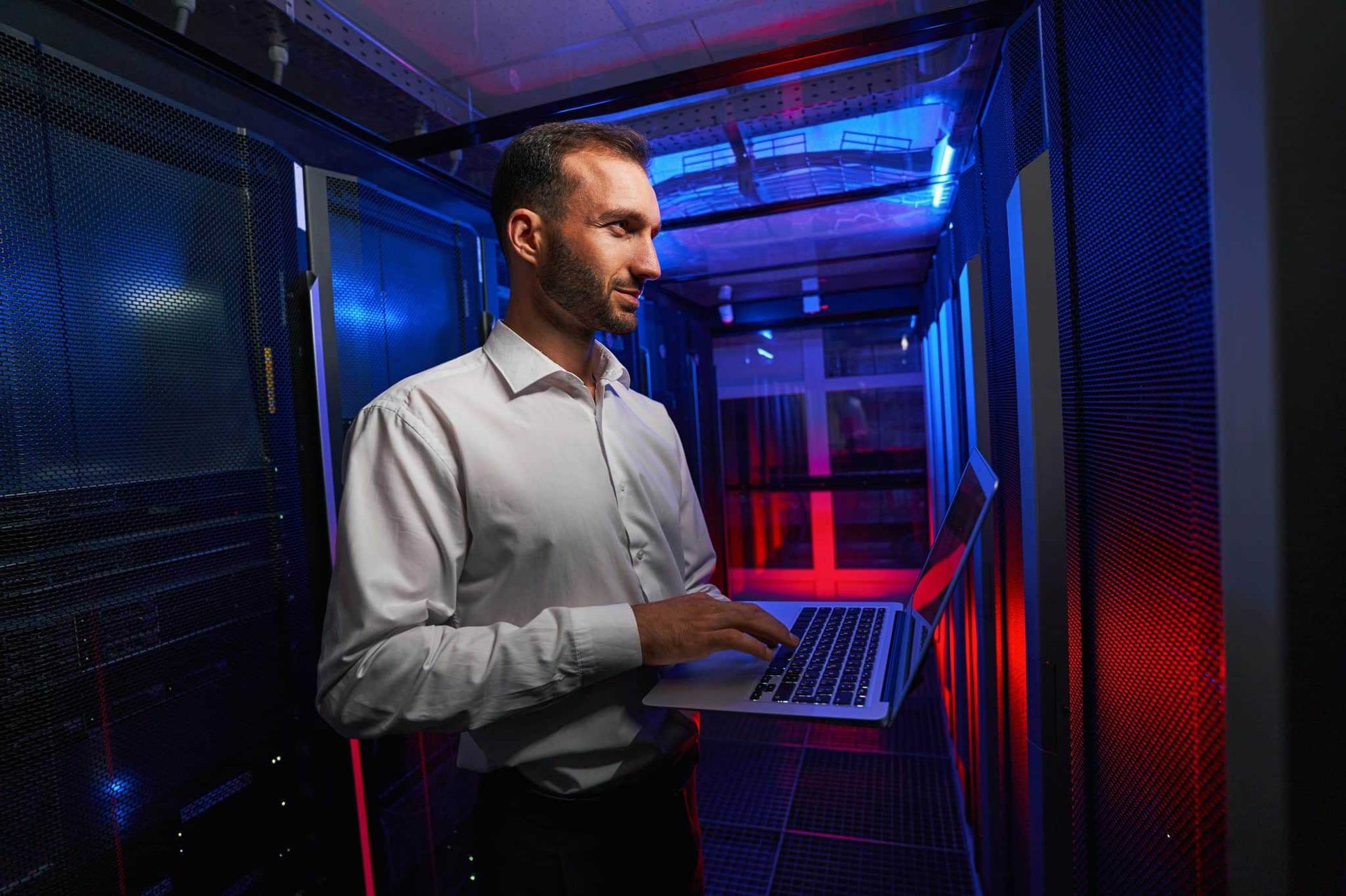 programmer troubleshooting while holding laptop