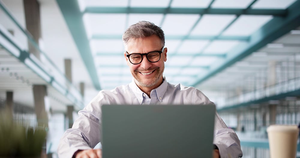 man at his computer receiving IT managed services help remotely