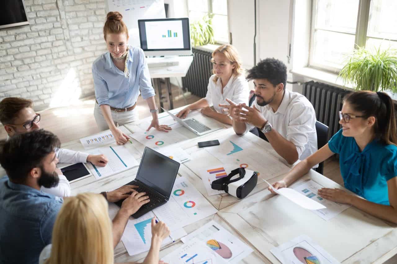 team gathered around conference table in lively discussion