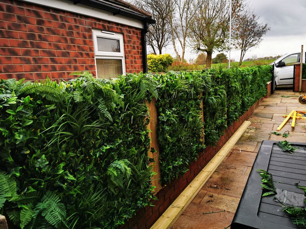 how to attach artificial hedge to brick wall