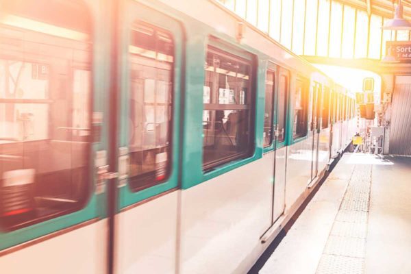 This image shows a Paris Metro subway train at station, the best way to reach the Latin Quarter from Gare du Nord.