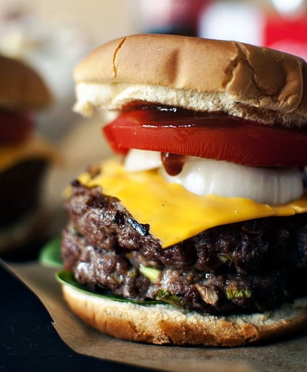 Two SUPER BOWL burgers are sitting on top of a piece of paper, creating an AWESOME visual suggestion.