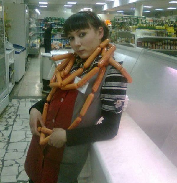 A woman is posing for a picture in a grocery store, capturing the essence of