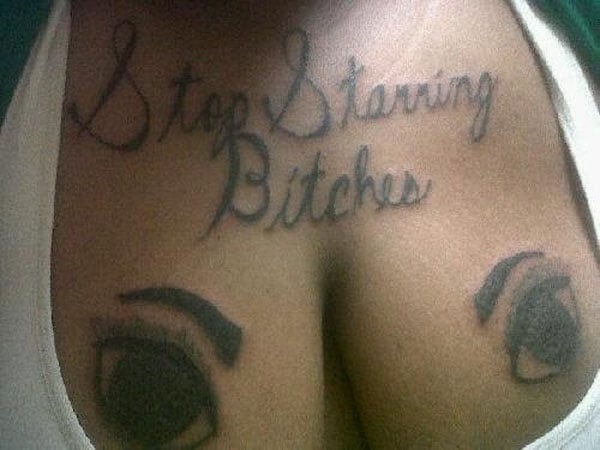 A woman with tattoos on her chest that make you feel better about your life.