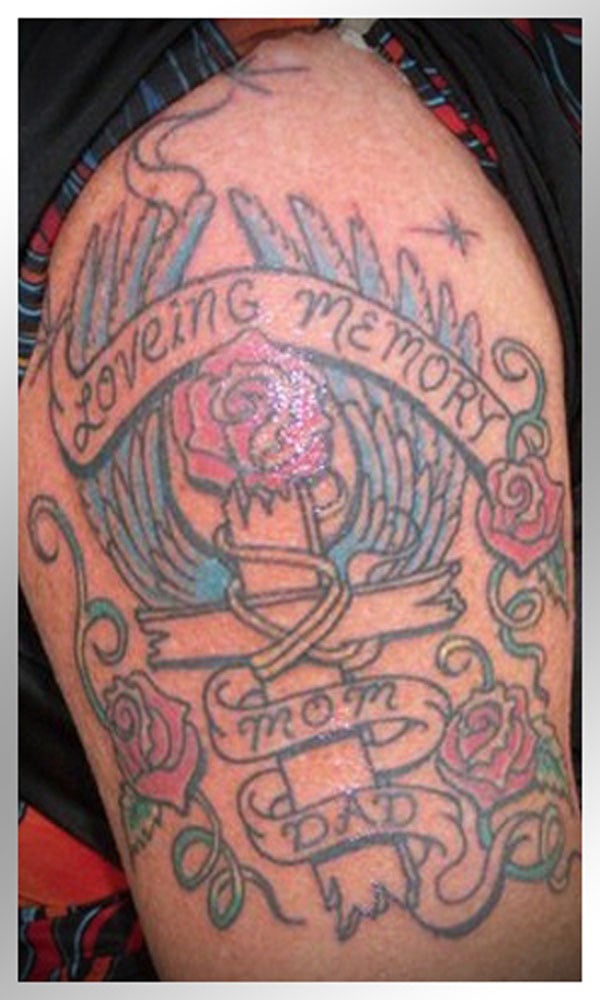 A tattoo featuring a cross and roses, one of 20 terrible tattoos that will make you happy you are you.