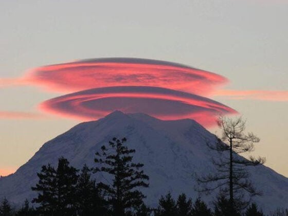 A stunning spherical cloud hovers over a majestic mountain at sunset, offering one of the 40 cool pics to brighten your day.