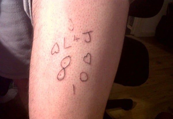 A man showcasing a regrettable tattoo, serving as a permanent reminder of a bad decision.