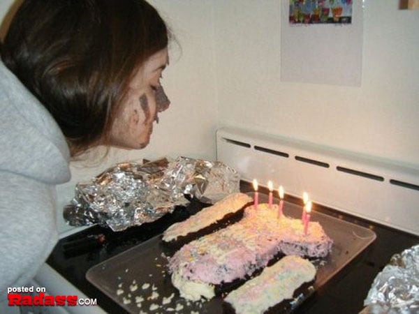 A woman blowing out candles on a birthday cake, surrounded by loved ones.