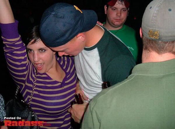 A group of people at a party with a man holding a beer.